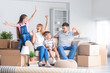 © Pixel-Shot - Happy family with belongings in their new house