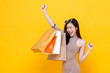 © Atstock Productions - Happy excited Asian woman carrying shopping bags with hand raising up