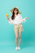 © Atstock Productions - Happy Asian woman in summer casual clothes holding a glass of fruit juice drink