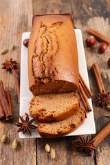 Sticker - gingerbread cake with spices on wood background