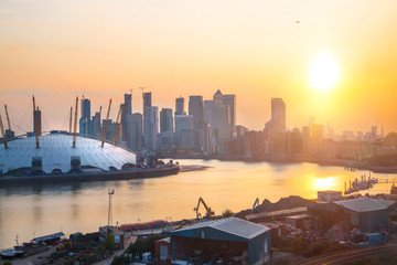 Wall Mural -  London at sunset. View includes Canary Wharf business and banking complex, docks, London arena and river Thames.