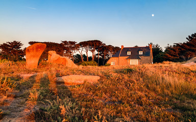 Wall Mural - Countryside sunset landscape with authentic old house on the Pink Granite Coast, (Cote de Granite Rose). Ploumanac'h, Perros-Guirec, Brittany, France, Europe.