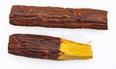 Wall Mural - Group of stick licorice bars (natural root licorice). Paloduz or Licorice Plant (Glycyrrhiza glabra, orozuz). Isolated on green background.