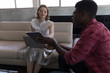© WavebreakMediaMicro - Male and female executives discussing over digital tablet in office