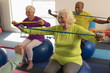 © WavebreakMediaMicro - Senior people exercising with resistance band in fitness studio
