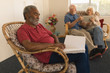 © WavebreakMediaMicro - Blind senior man reading a braille book while senior couple using digital tablet at nursing home
