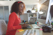© WavebreakMediaMicro - Happy female graphic designer using graphic tablet at desk