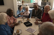 © wavebreak3 - Group of senior friends having breakfast on dining table at nursing home
