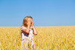 © Andrey_Arkusha - Little girl in a wheat golden field