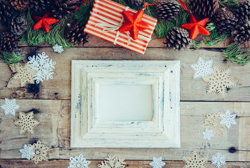 Wall Mural - Christmas background with frame and gift boxes on the wooden tab