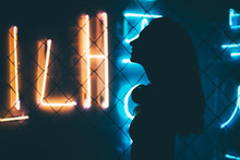 Silhouette Of Girl In A Nightclub. Attractive Dancing Girl In The Club, Hair Flying, Neon Light, Motion Effects.