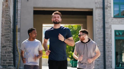 Wall Mural - fitness, sport and healthy lifestyle concept - happy young men or male friends running outdoors