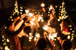 © MaaHoo Studio/Stocksy - Group of friends holding burning sparklers and dancing