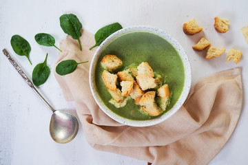 Vegetarian broccoli and spinach soup with croutons. Green healthy food concept. Top view