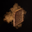 © Yaroslav Danylchenko/Stocksy - Flying crisp dry rye toast with fragrant steam on a black backgr