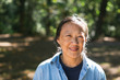 © Rob and Julia Campbell/Stocksy - Mature asian woman practicing tai chi outside.