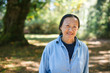 © Rob and Julia Campbell/Stocksy - Mature asian woman practicing tai chi outside.