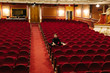© Javier D?ez/Stocksy - Male dancer sitting in theatre auditorium
