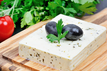 Poster - Herbs cheese with olive and cherry tomatoes on a cutting board