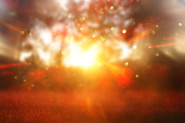 abstract background of light burst among trees and glitter golden bokeh lights