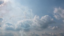 Group Of Four Planes Fulfills Aerobatic Figures In A Cloudy Sky With Smoke