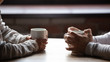 © fizkes - Close up woman and man holding cups of coffee on table