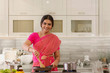 © IndiaPix - woman in saree cooking in the kitchen