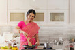 © IndiaPix - woman in saree cooking in the kitchen