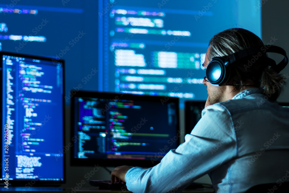 Software developer freelancer man male in headphones work with program ...