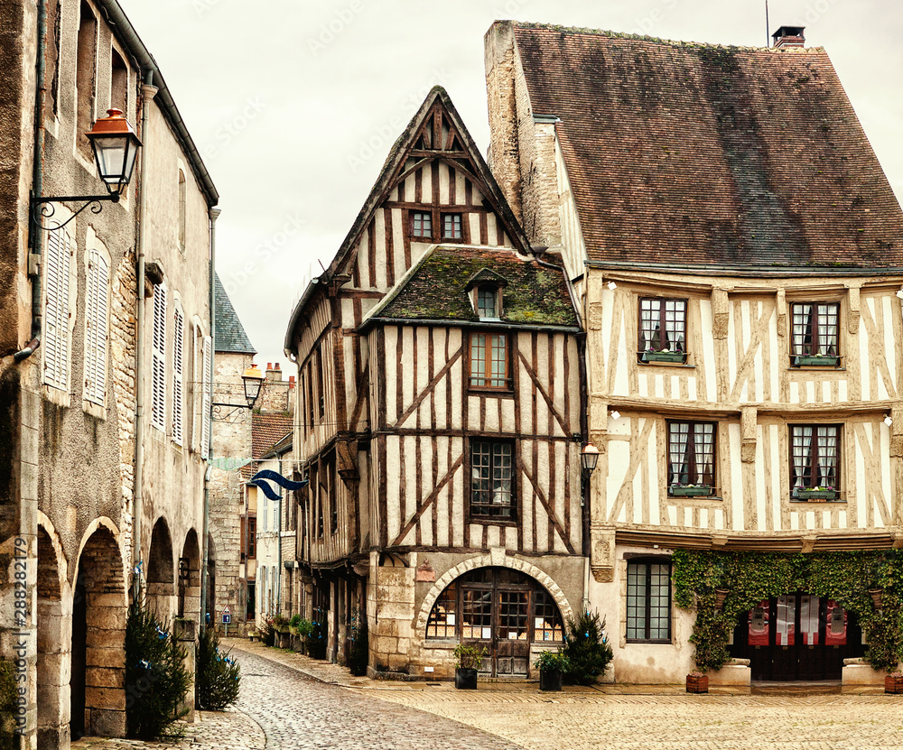 Old half-timbered houses on Town Hall Square of Noyers (Noyers-sur-Serein).   Noyers is beautiful medieval French village  in Burgundy, north-central France.