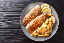 Grilled Fish Mackerel Fillet With A Side Dish Of Fried Potatoes Close-up On A Plate. Horizontal Top View