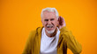 © motortion - Senior man trying to hear interlocutor, health problems of aged people, deafness