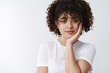 © Cookie Studio - Tender feminine european curly-haired girl clean skin pure face touch cheek smiling gently look happy friendly camera, standing white background delighted listening interest feel joyful