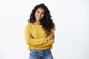 Wall Mural - Happiness, wellbeing and confidence concept. Cheerful attractive african american woman curly haircut, cross arms chest in self-assured powerful pose, smiling determined, wear yellow sweater