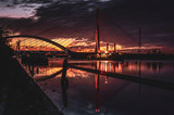 Fototapeta Mosty linowy / wiszący - Wschód słońca nad rzeką, krajobraz miejski, mosty. 