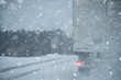 Truck is driving on a winter road in a blizzard	