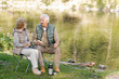 © pressmaster - Mature affectionate man and woman in activewear having tea with sandwiches