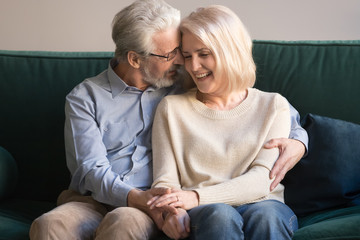 Elder senior smiling happy family couple hugging at home.