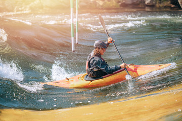 Wall Mural - Guy in kayak sails mountain river. Whitewater kayaking, extreme sport rafting