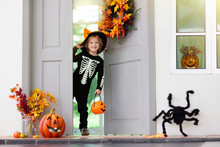 Kids Trick Or Treat. Halloween. Child At Door.