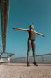 © shevchukandrey - Sportswoman doing exercises on the bridge stock photo