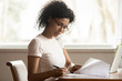 Focused biracial woman in glasses study correct paperwork