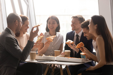 Overjoyed company multiracial staff employees gathered for lunch meal.