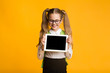© Prostock-studio - School Girl Showing Empty Tablet Screen, Yellow Background, Mockup