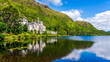 Kylemore Abbey, beautiful castle like abbey reflected in lake at the foot of a mountain. Benedictine monastery founded in 1920, in Connemara, Ireland