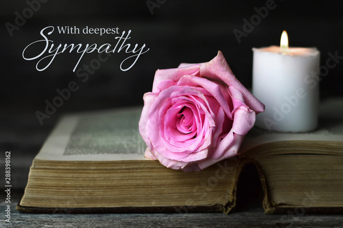 Fotografía Sympathy card with burning candle and rose on open book
