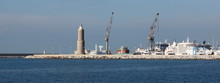 Scenic View Of Livorno Harbor With Lighthouse, Cranes And Cruise Ships In Italy