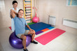 © Yakobchuk Olena - Happy man doing exercises on a fintes ball
