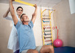 © Yakobchuk Olena - Happy male patient doing exercises with hands