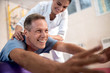 © Yakobchuk Olena - Happy mature patient is doing rehab exercises
